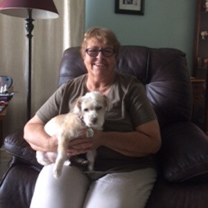 A seated woman with a small dog